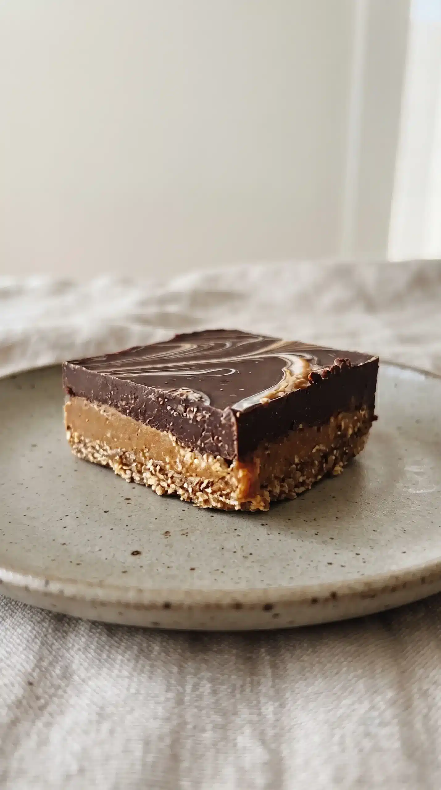Chocolate Peanut Butter Bars showing a firm chocolate top and chewy oat base